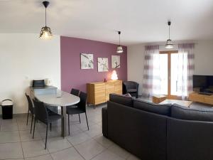 a living room with a couch and a table and chairs at Gîte Ferdrupt, 2 pièces, 2 personnes - FR-1-589-101 in Ferdrupt