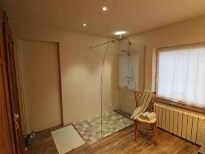 a shower in a room with a chair and a glass door at Maison cosy à Gérardmer avec 2 chambres et terrasse ensoleillée, proche activités - FR-1-589-110 in Gérardmer