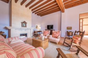 a living room with a couch and a fireplace at Finca La Encina by Mallorca House Rent in Porreres