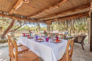 a long table under a pergola on a patio at Finca La Encina by Mallorca House Rent in Porreres