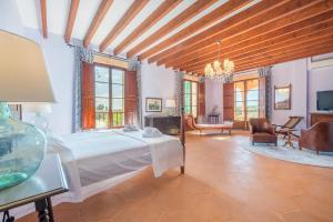 a bedroom with a bed and a living room at Finca La Encina by Mallorca House Rent in Porreres +49 photos