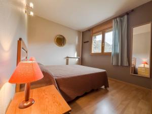 a bedroom with a bed and a lamp on a table at Nuria Pedrous in Pas de la Casa