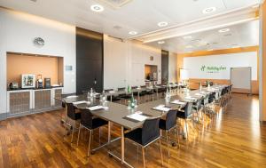 a conference room with a long table and chairs at Holiday Inn Bern Westside by IHG in Bern