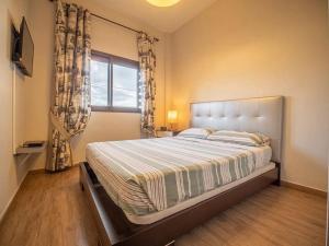 a bedroom with a large bed and a window at Villa El Tagoro in Candelaria