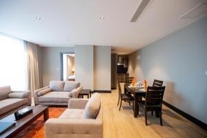 a living room with a couch and a table at Sincerely Yours Suites & Serviced Apartments in Nairobi
