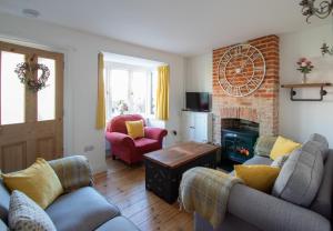 a living room with two couches and a fireplace at Stylish Town Centre House with Garden and Parking Opposite in Bury Saint Edmunds