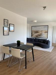 a living room with a table and a couch at Ostwall Terrassen Apartment 5.33 in Bocholt