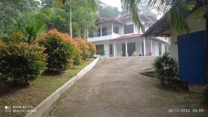 a house with a driveway in front of it at Villa RnG in Dickwella