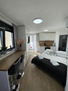 a bedroom with a bed and a desk with a computer at Villa Laverna Annex in Novalja