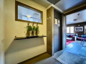 a hallway with a window and plants on a shelf at City Apartments by Malmedreams in Malmedy