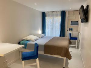 a small bedroom with a bed and a window at Paris Canal Studio - Gare de l'Est in Paris