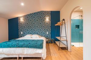 a bedroom with a bed and a blue wall at Chambres d'hôtes - Domaine de Cristia in Courthézon