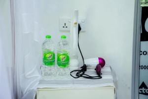 a refrigerator with two bottles of soda and a phone at Galaxy View Homestay Sigiriya in Sigiriya