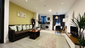 a living room with a couch and a kitchen at Naps Inn in Birmingham