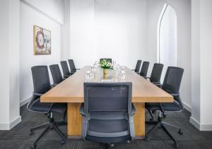 a conference room with a long wooden table and chairs at Central Inn Souq Waqif in Doha