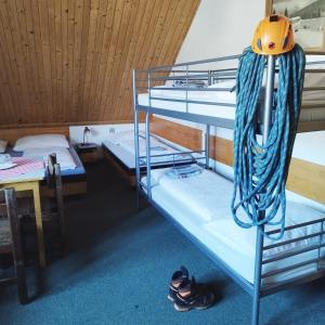 a bunk bed room with two bunk beds and shoes at Turistické ubytovanie Sova in Ždiar