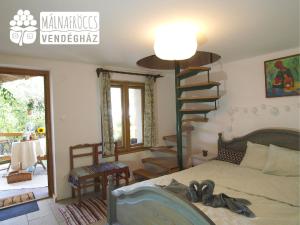 1 dormitorio con 1 cama y escalera de caracol en Málnafröccs Vendégház Nagymaros, en Nagymaros