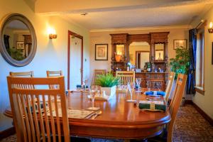 a dining room with a wooden table with chairs at Crubenbeg Country House in Newtonmore