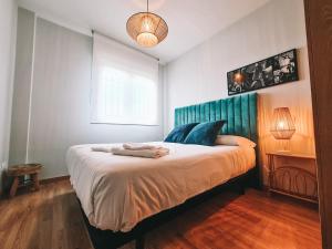 um quarto com uma cama grande e uma cabeceira azul em Casa Robledo em Palazuelos de Eresma