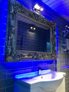 a bathroom with a mirror and a sink at 77 Park Road Apartments in Blackpool