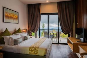 a hotel room with a bed and a balcony at Mountain Valley Resort in Kundasang