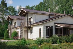 a house with a metal roof on top of it at Holiday Club Saimaa Superior Apartments in Imatra