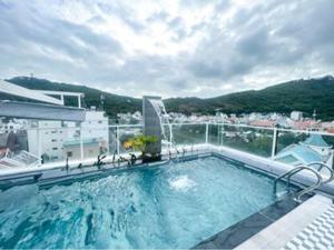 a large swimming pool on top of a building at Nếp Apartment Hotel in Vung Tau