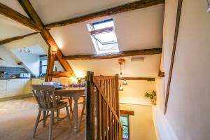 a kitchen and dining room with a table and a window at Kestrel Cottage in Builth Wells
