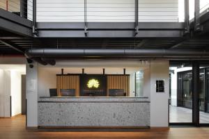 a lobby of a building with a sign on the wall at VERSOVERDE HOTEL Alzaia Naviglio Grande in Milan