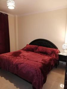 A bed or beds in a room at Comfortable studio in madinaty compound B11