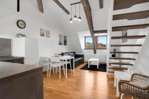 a kitchen and living room with a table and chairs at U Pivovaru - Apartments Boží Dar in Boží Dar