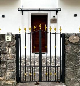 a black and gold gate in front of a door at Dimora T'ama in San Lorenzello
