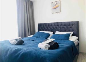 a bed with blue sheets and towels on it at Ultra Lux in New Gudauri in Gudauri