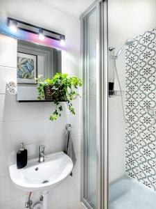 a bathroom with a sink and a shower at Gogol Studio Apartment in Budapest