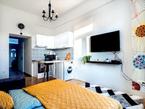 a living room with a bed and a kitchen at Gogol Studio Apartment in Budapest