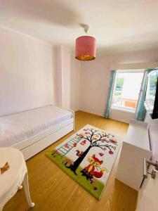 a bedroom with a bed and a rug on the floor at Cabedelo Beach Loft in Darque +29 photos
