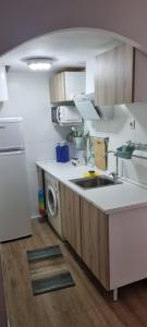 a kitchen with a sink and a washing machine at Apartamento 309 frente al mar en Alcossebre in Alcossebre