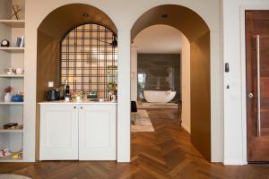 a bathroom with white cabinets and a bath tub at Alonella in Kefar Weradim