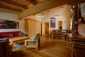 a living room with a couch and a table at Chesa Munteratsch 2-Zimmerwohnung 301 Typ E in Silvaplana