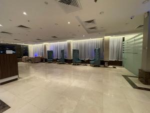 a lobby with a waiting room with chairs and windows at Staytion Express Orjwan Lebanon in Jeddah