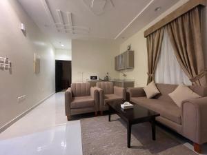 a living room with a couch and chairs and a table at Staytion Express Orjwan Lebanon in Jeddah