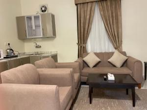 a living room with a couch and a table at Staytion Express Orjwan Lebanon in Jeddah