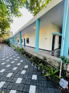 a row of buildings with blue columns on a sidewalk at Hotel green park in Jabalpur