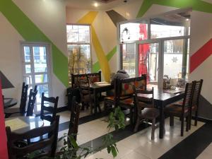a dining room with tables and chairs in a restaurant at Саквояж Вокзал in Lviv