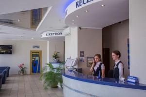 two women standing at a reception desk in a hospital at Sputnik Hotel in Minsk