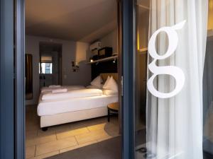 Postel nebo postele na pokoji v ubytování grätzlhotel Karmelitermarkt