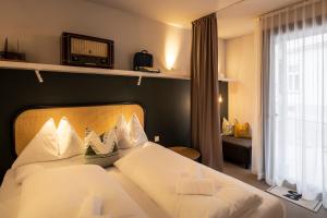 Postel nebo postele na pokoji v ubytování grätzlhotel Karmelitermarkt