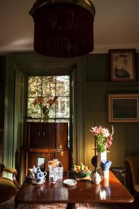 a room with a table and a window at The Historical Harcourt Suites in Dublin