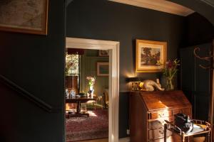 a room with a desk and a table and a door at The Historical Harcourt Suites in Dublin