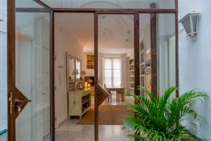 a hallway with glass doors and a plant at Eva Recommends Gamazo in Seville